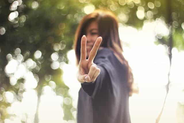 A Person Holding Up A Victory Sign - Context - After Having Used The Computer Science Homework Help Person Is Feeling Satisfied And Is Holding Up The Peace / Victory Sign.